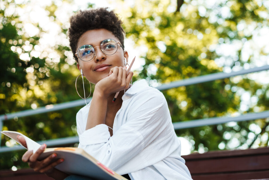 Concentrated african woman reading book